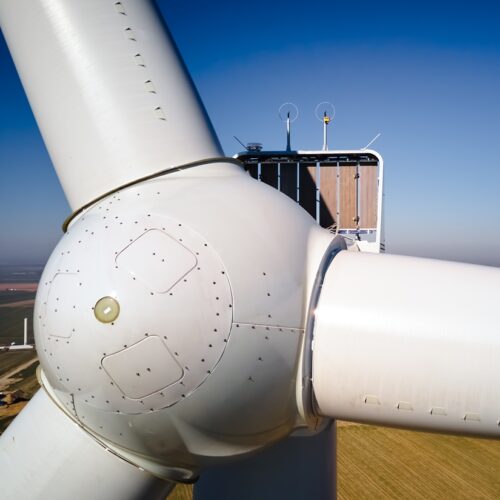 Aerial view of close up windmill turbine in countryside area, Wind power and renewable sustainable energy concept